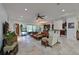 Bright living room with view of patio area and open access to kitchen, modern decor and recessed lighting at 931 Mangrove Edge Ct, Bradenton, FL 34208