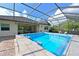 Enclosed pool with view of home's exterior and tropical foliage at 931 Mangrove Edge Ct, Bradenton, FL 34208