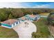 Aerial view of a luxurious home with a pool, tennis court, and lush landscaping at 1101 Palm View Rd, Sarasota, FL 34240