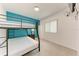 Bedroom with a bunk bed and teal accent wall at 1101 Palm View Rd, Sarasota, FL 34240