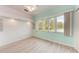 Bright bedroom with large windows, light walls, and wood-look floors at 1101 Palm View Rd, Sarasota, FL 34240