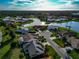 Aerial view of a residential neighborhood near a lake at 1200 Covey Ct, Venice, FL 34293