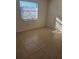 Bright bedroom with tile floors and large window at 1313 54Th E Ave # 1313, Bradenton, FL 34203