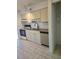 Kitchen with light cabinets, granite counters, and tile floor at 1313 54Th E Ave # 1313, Bradenton, FL 34203