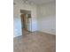 Living room with tile floors and view into kitchen at 1313 54Th E Ave # 1313, Bradenton, FL 34203