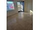 Bright living room with tile flooring and view of exterior at 1313 54Th E Ave # 1313, Bradenton, FL 34203