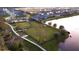 Community overview showcasing homes, landscaping and lake at 13930 Old Creek Ct, Parrish, FL 34219