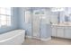 Bathroom with a shower, a soaking tub, and white cabinets at 13930 Old Creek Ct, Parrish, FL 34219