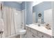Clean bathroom with white vanity, tub, shower, and light blue walls at 13930 Old Creek Ct, Parrish, FL 34219