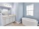 Bathroom with soaking tub, shower, and white cabinets at 13930 Old Creek Ct, Parrish, FL 34219