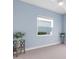Light blue bedroom with carpeted floor, window, and ceiling fan at 13930 Old Creek Ct, Parrish, FL 34219
