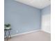 Spacious bedroom with light blue walls, ceiling fan, and double doors at 13930 Old Creek Ct, Parrish, FL 34219