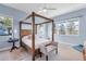 Bedroom with a wooden canopy bed and large windows at 13930 Old Creek Ct, Parrish, FL 34219