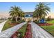 The Gather Place community clubhouse with palm trees and landscaping at 13930 Old Creek Ct, Parrish, FL 34219