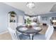 Charming dining room with a round wooden table and white chairs at 13930 Old Creek Ct, Parrish, FL 34219