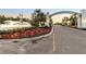 Gated entrance to Canoe Creek, featuring a welcoming arch and landscaping at 13930 Old Creek Ct, Parrish, FL 34219