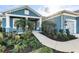 Landscaped front yard with palm trees and walkway leading to the front porch at 13930 Old Creek Ct, Parrish, FL 34219