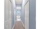 Hallway with light blue walls and white doors leading to bathroom at 13930 Old Creek Ct, Parrish, FL 34219
