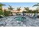 Relaxing hot tub surrounded by lounge chairs and palm trees at 13930 Old Creek Ct, Parrish, FL 34219