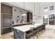 Modern community kitchen with dark cabinetry, white countertops, and stylish backsplash at 13930 Old Creek Ct, Parrish, FL 34219