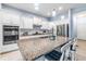 Modern kitchen with white cabinets, granite countertops, and stainless steel appliances at 13930 Old Creek Ct, Parrish, FL 34219
