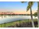 Serene lake view from behind a black metal fence with palm trees in foreground at 13930 Old Creek Ct, Parrish, FL 34219