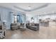 Spacious living room with light blue walls and access to the backyard at 13930 Old Creek Ct, Parrish, FL 34219