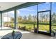 Screened porch overlooking a backyard with a pond view at 13930 Old Creek Ct, Parrish, FL 34219