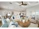 Bright living room with hardwood floors, comfortable seating, and a view to the kitchen at 14587 Bald Cypress Way, Nokomis, FL 34275