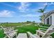 Enjoy the view of the golf course from this home's backyard with comfy seating at 15415 Derna Ter, Bradenton, FL 34211