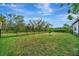 Private backyard with grassy area and a black metal fence at 15415 Derna Ter, Bradenton, FL 34211