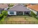 Aerial view of backyard with screened patio, fenced yard, and mature landscaping at 15415 Derna Ter, Bradenton, FL 34211