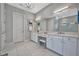 Elegant bathroom with double vanity, white cabinets, and marble flooring at 15415 Derna Ter, Bradenton, FL 34211
