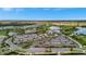 Aerial view of community clubhouse with expansive parking and surrounding landscape at 15415 Derna Ter, Bradenton, FL 34211