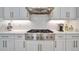 Stainless steel gas cooktop with six burners and modern range hood at 15415 Derna Ter, Bradenton, FL 34211
