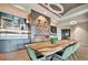 Community dining room with a large live-edge table and modern chairs at 15415 Derna Ter, Bradenton, FL 34211