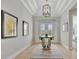 Bright and spacious entryway with hardwood floors and a round glass table at 15415 Derna Ter, Bradenton, FL 34211