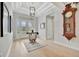 Entryway with hardwood floors, a unique table, and antique clock at 15415 Derna Ter, Bradenton, FL 34211