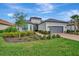 House exterior showcasing a manicured lawn and brick driveway at 15415 Derna Ter, Bradenton, FL 34211