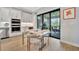 Kitchen nook with light wood table and four gold chairs, leading to a patio at 15415 Derna Ter, Bradenton, FL 34211