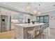 Modern kitchen with white cabinets, island, and stainless appliances at 15415 Derna Ter, Bradenton, FL 34211
