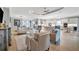 Open living room with light leather sofas and a view into the kitchen at 15415 Derna Ter, Bradenton, FL 34211