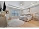 Spacious main bedroom with light flooring, large window, and neutral decor at 15415 Derna Ter, Bradenton, FL 34211