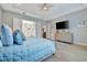 Main bedroom with ensuite bathroom, dresser, and light blue bedding at 15415 Derna Ter, Bradenton, FL 34211