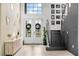 Bright entryway with modern console table and staircase at 15815 Tradewind Ter, Bradenton, FL 34211