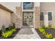 Double front doors with stone columns and lush landscaping at 15815 Tradewind Ter, Bradenton, FL 34211