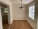Charming dining area with light wood floors and a chandelier at 1630 29Th St, Sarasota, FL 34234
