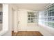 Bright sunroom with wood floors and window blinds at 1630 29Th St, Sarasota, FL 34234