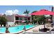 Community pool with lounge chairs and umbrellas at 1801 Gulf N Dr # 256, Bradenton Beach, FL 34217