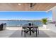 Balcony dining area with water views and bridge at 188 Golden Gate Pt # 202, Sarasota, FL 34236